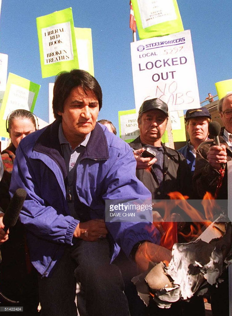 1996: Chief Ovide Mercredi of the Assembly of First Nations burns a copy of the Liberal Red Book outside the Liberal Party Convention in Ottawa.